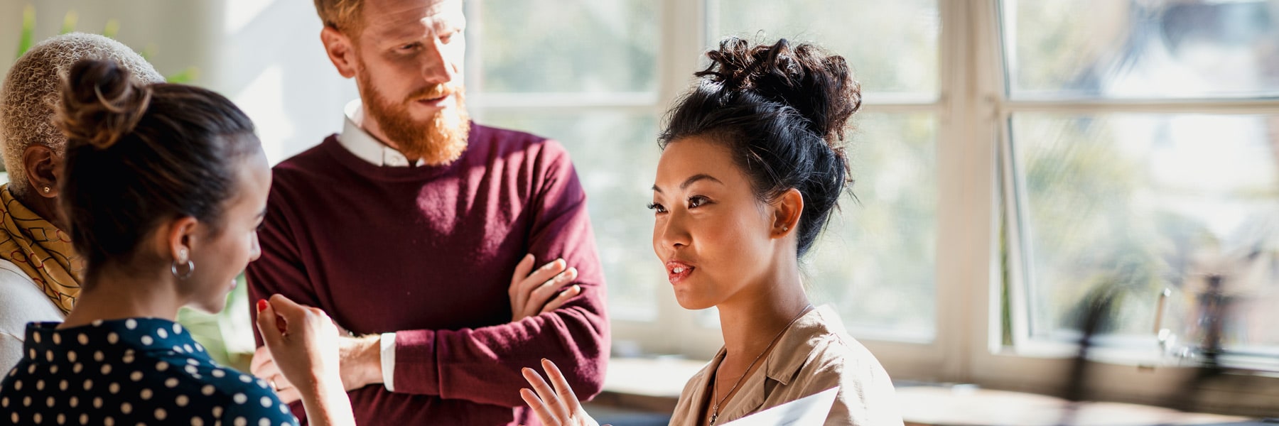 Stock image: Bored schoolboy looking away while sitting at desk with girl in background at classroom | By: Tyler Olson